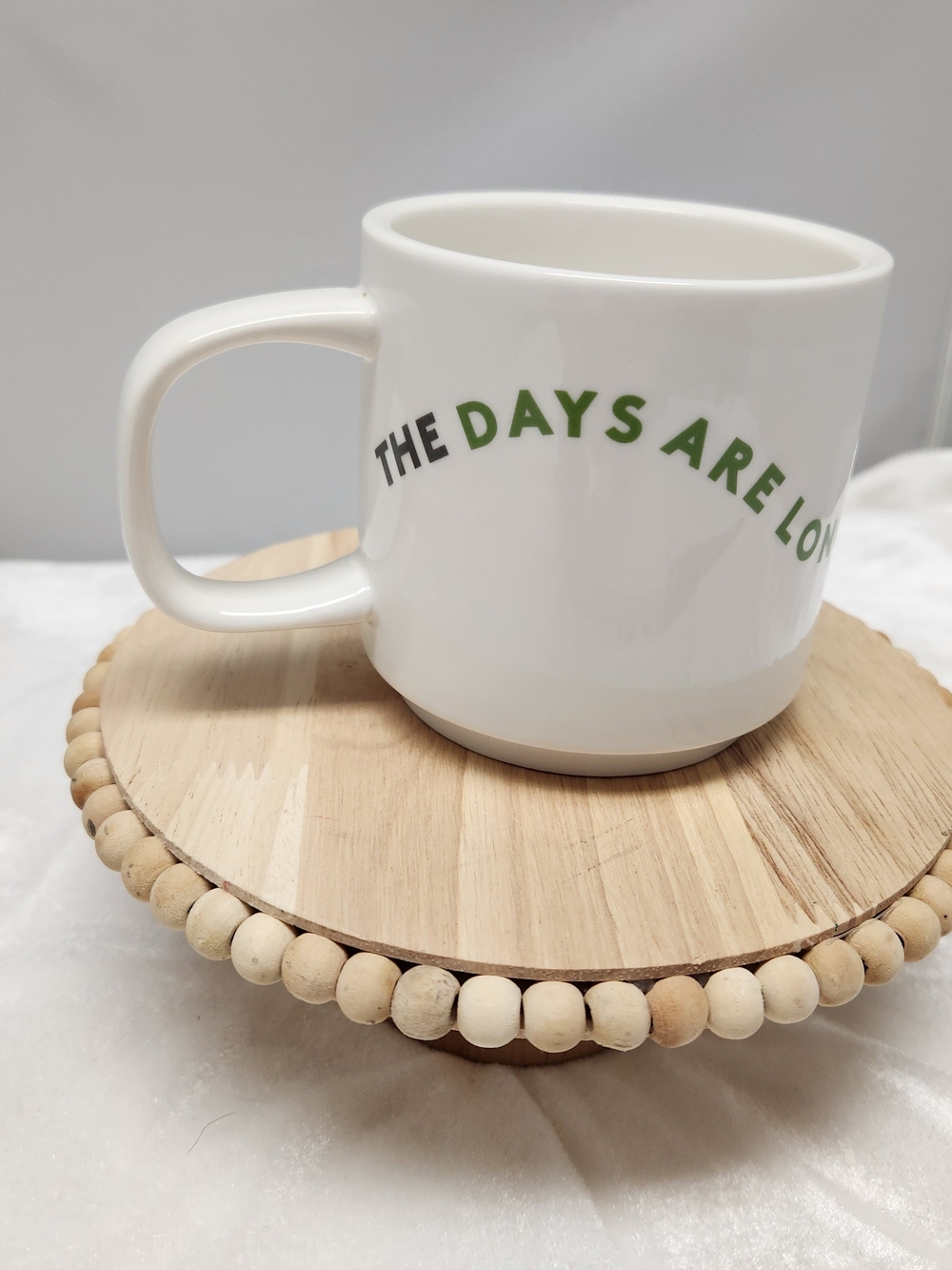 White Ceramic Mug with Green Slogan - 'The Days Are Long But The Years Are Short